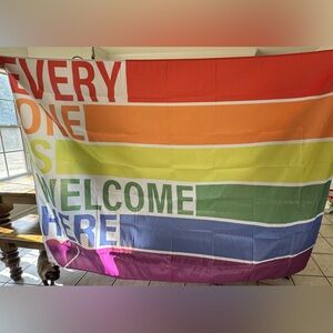 OVERSIZED “EVERYONE IS WELCOME HERE” PRIDE RAINBOW BANNER